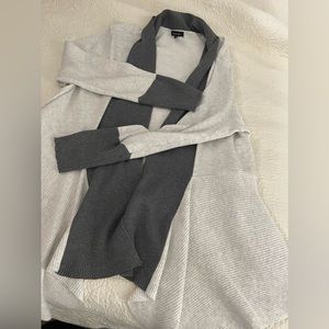 Beautiful soft heather draped sweater with distinct and dramatic hemline.